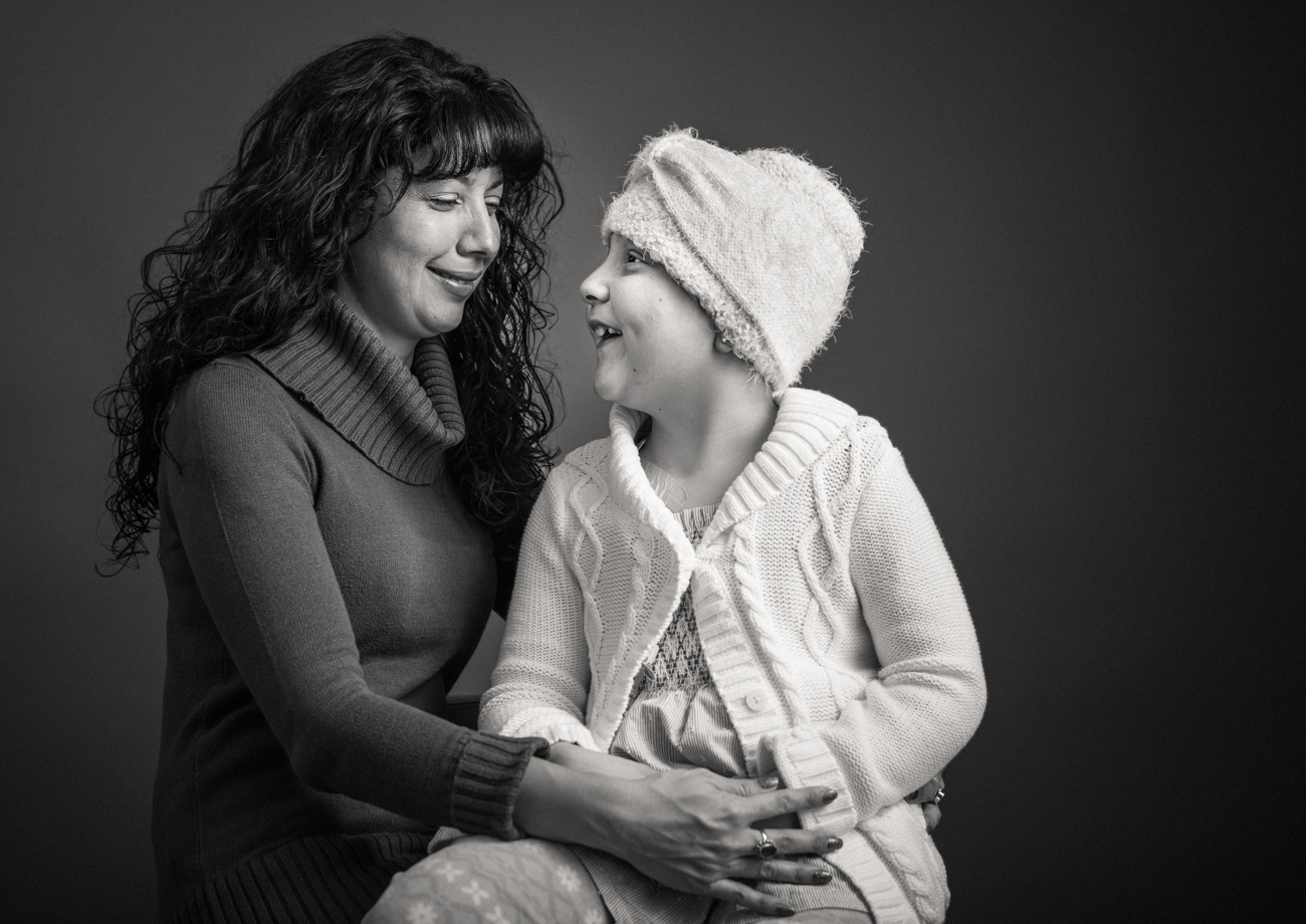 Flashes of Hope, portrait of a young girl batting cancer smiling at her mother. Family support, hug, loving, warm, together, resilience, authentic, love, Nashville, portrait, editorial, documentary, news, photographer, Kristina Krug