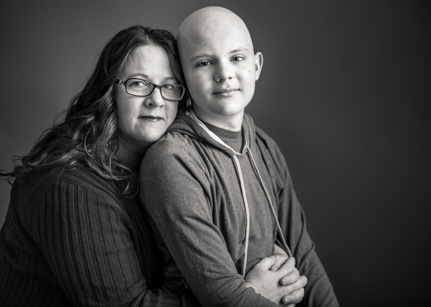 Flashes of Hope, portrait of a mother hugger her son who is fighting cancer. Family, young, man, boy, loving, warm, together, resilience, authentic, love, Nashville, portrait, editorial, documentary, news, photographer, Kristina Krug