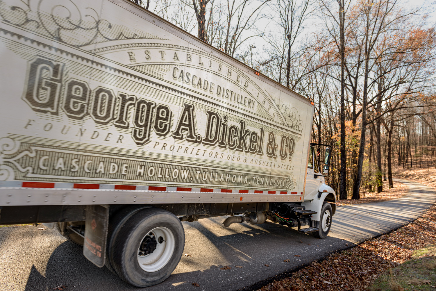 Truck driving down a road at George Dickel Distillery in Tennessee by editorial photographer Kristina Krug Photographer