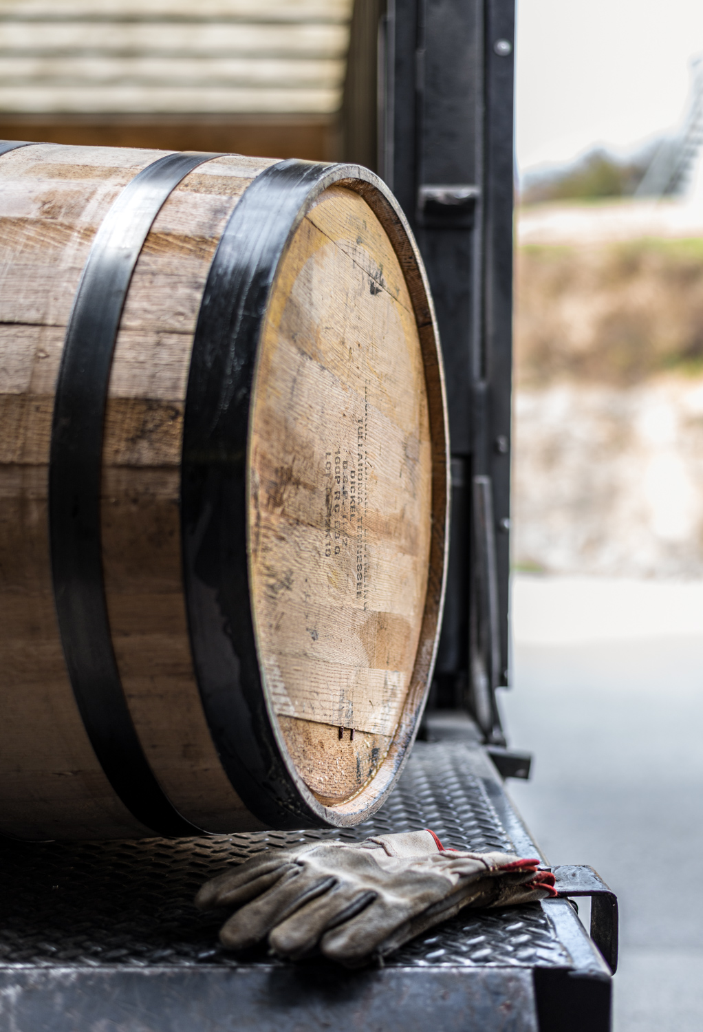 Barrel of whisky with work gloves on a truck at George Dickel Distillery. Rights-managed stock photo.