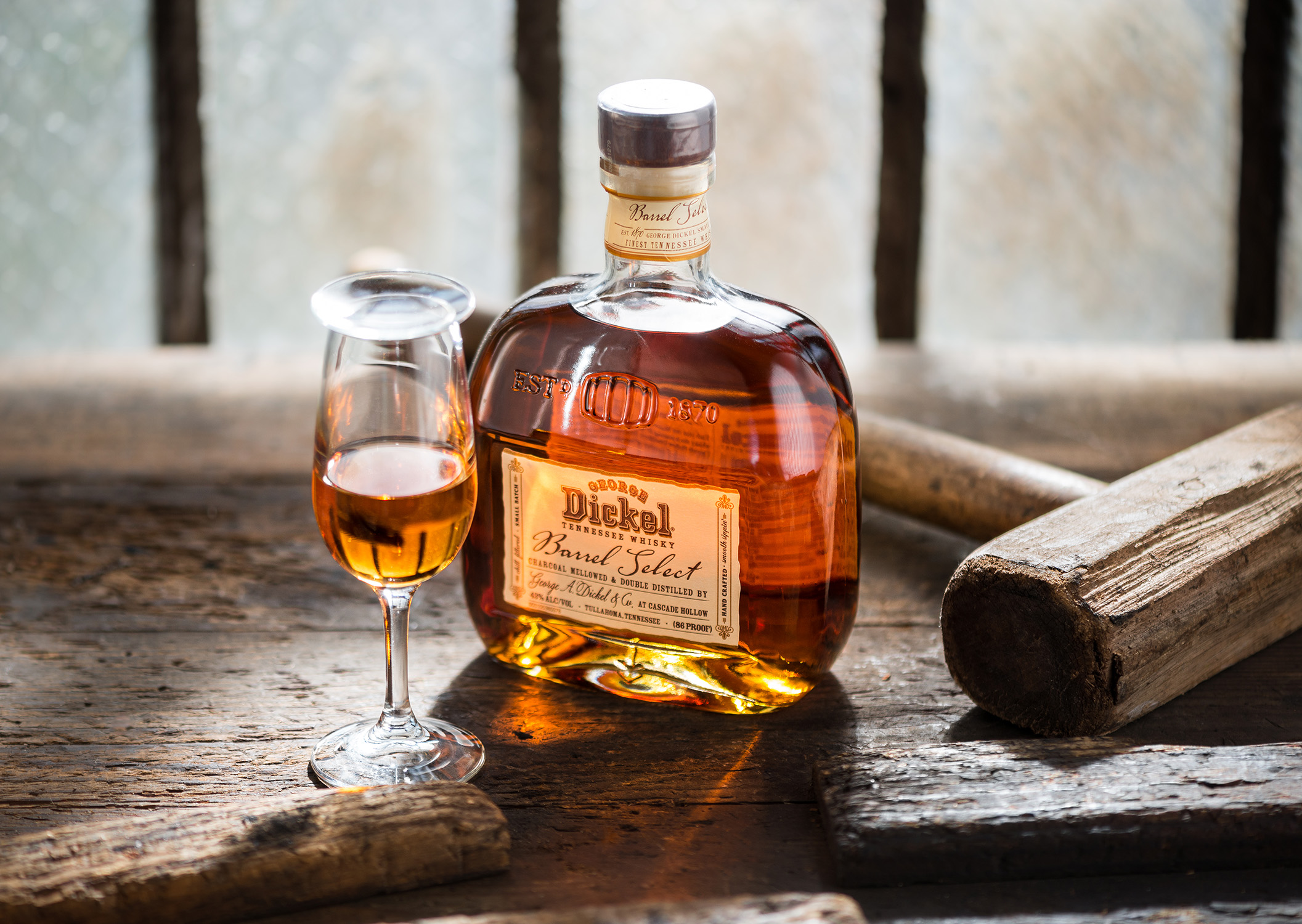 A bottle of George Dickel Barrel Select Whiskey on a rustic antique tool shed workbench. A brand narrative by Chicago and Nashville Editorial Food and Product Photographer Kristina Krug