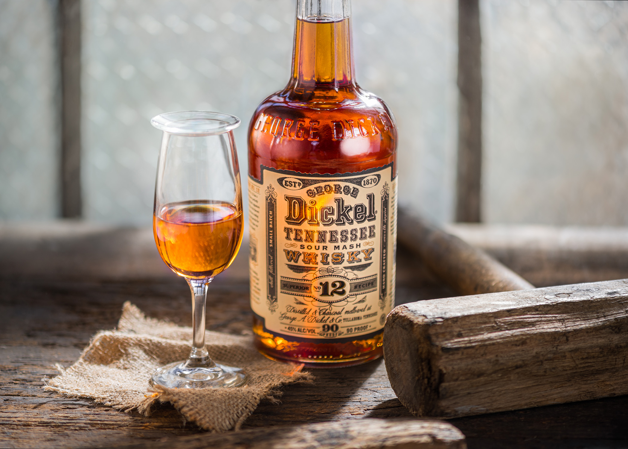 A bottle of George Dickel Small Batch 12 Year Superior Whiskey on a rustic antique tool shed workbench. Chicago and Nashville editorial, food, beverage, and travel photographer, Kristina Krug