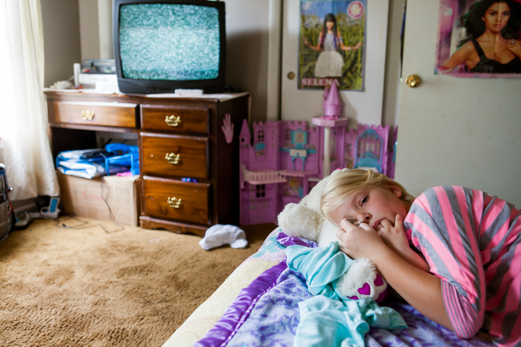 Girl in her room with fuzzy tv screen. Tullahoma, Tennessee. Documentary, real, authentic, day in the life, editorial, reportage, travel, cause marketing, non-profit, food, beverage, photographer, photojournalist, journalist, pictures, photos, photographs, photo, journalist, Austin, Mississippi, Louisiana, New Orleans, Carbondale, Chattanooga, Washington DC, Louisville, Lexington, Johnson City, Knoxville, Asheville, NC, North Carolina, Nashville, Memphis, Tennessee, TN, Atlanta, Athens, Savannah, Georgia, GA, Chicago, Illinois, Southeast, Midwest, St. Louis, Missouri, Indiana, Indianapolis, Cincinnati, Little Rock, Arkansas, AK, portrait, freelancer, freelance, women in photography, women-owned business, travel photographer