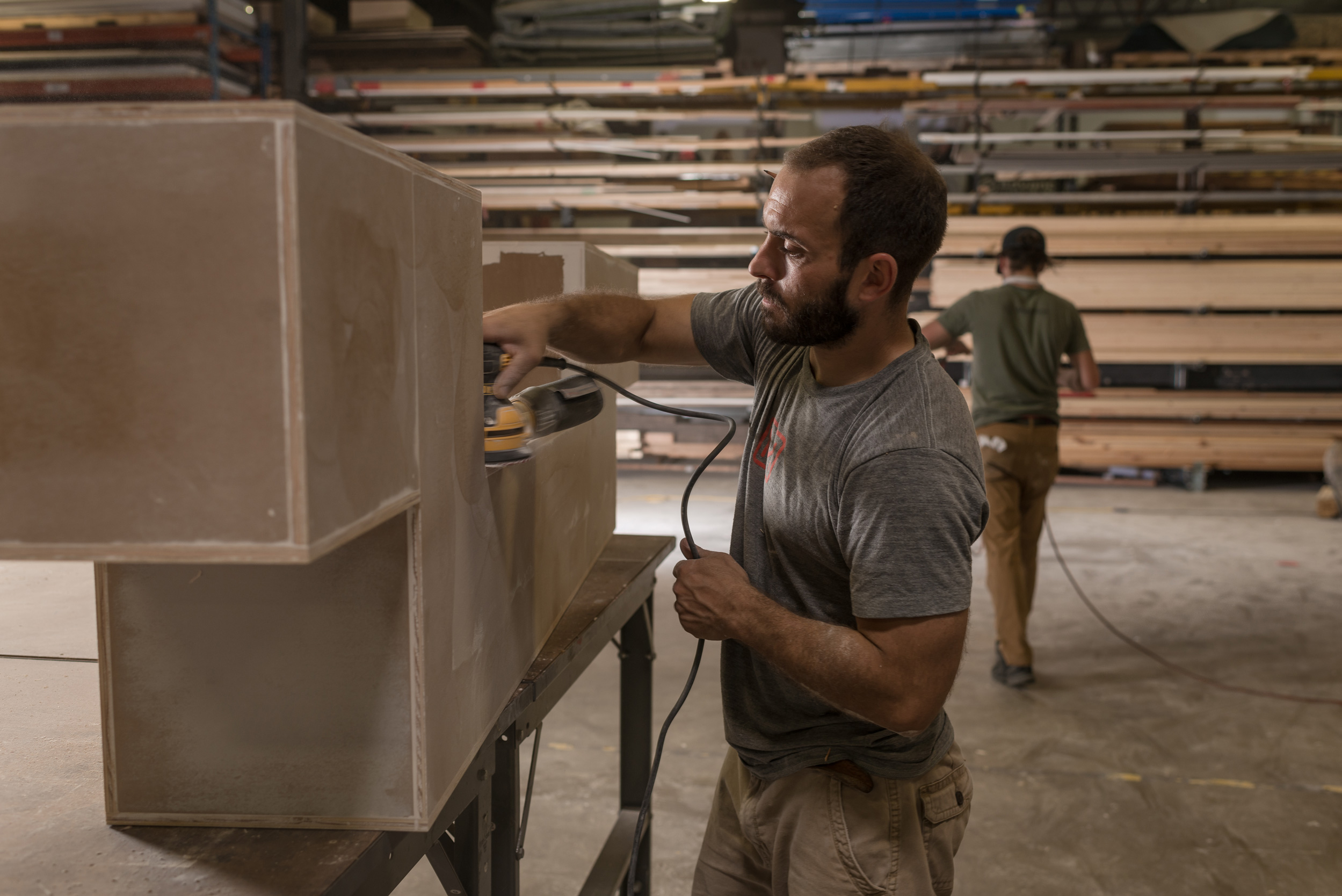 Man sanding a custom built display piece at MadeFirst in Nashville by advertising photographer Kristina Krug