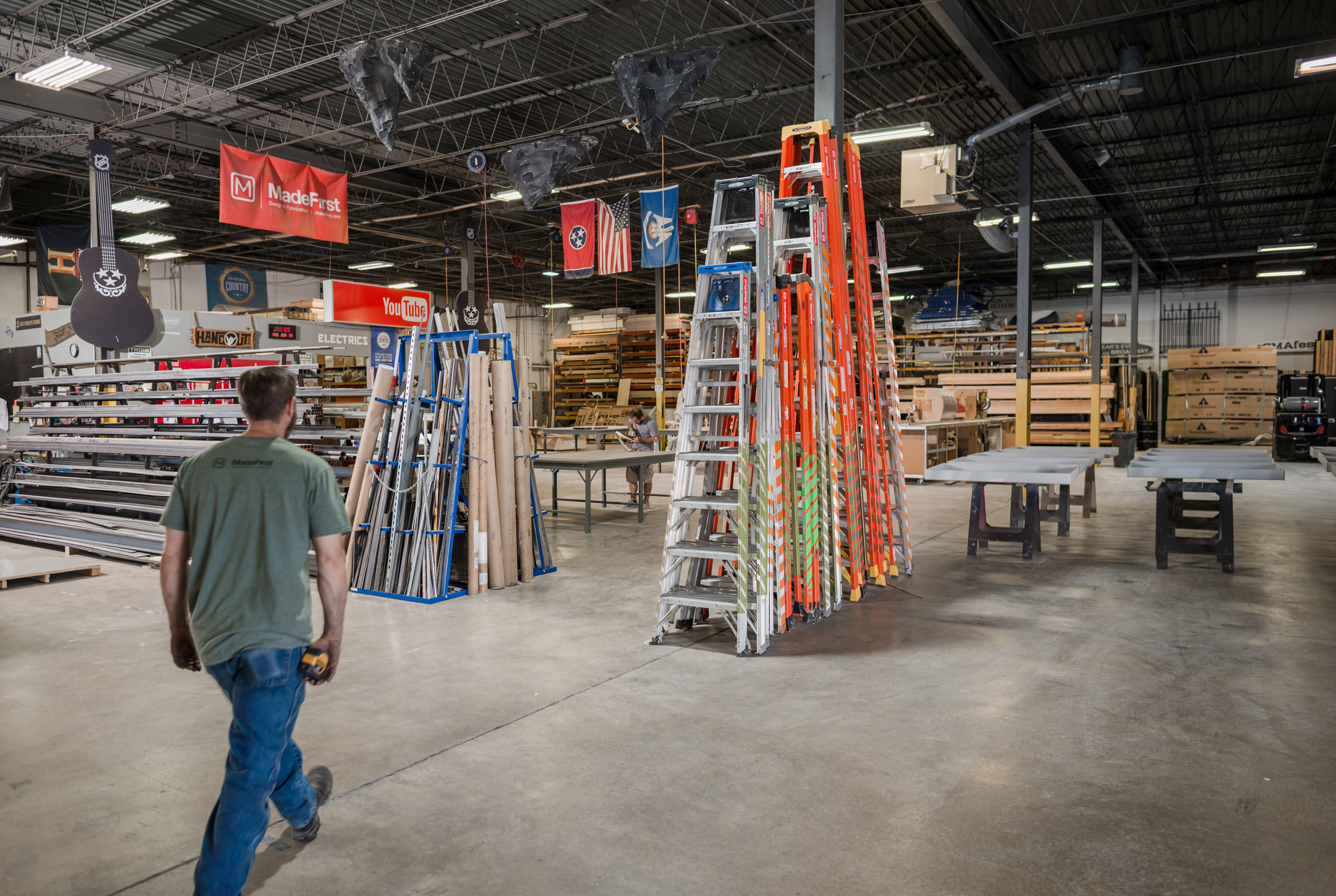 Man at work walking through a warehouse with ladders and construction supplies in Nashville, Tennessee