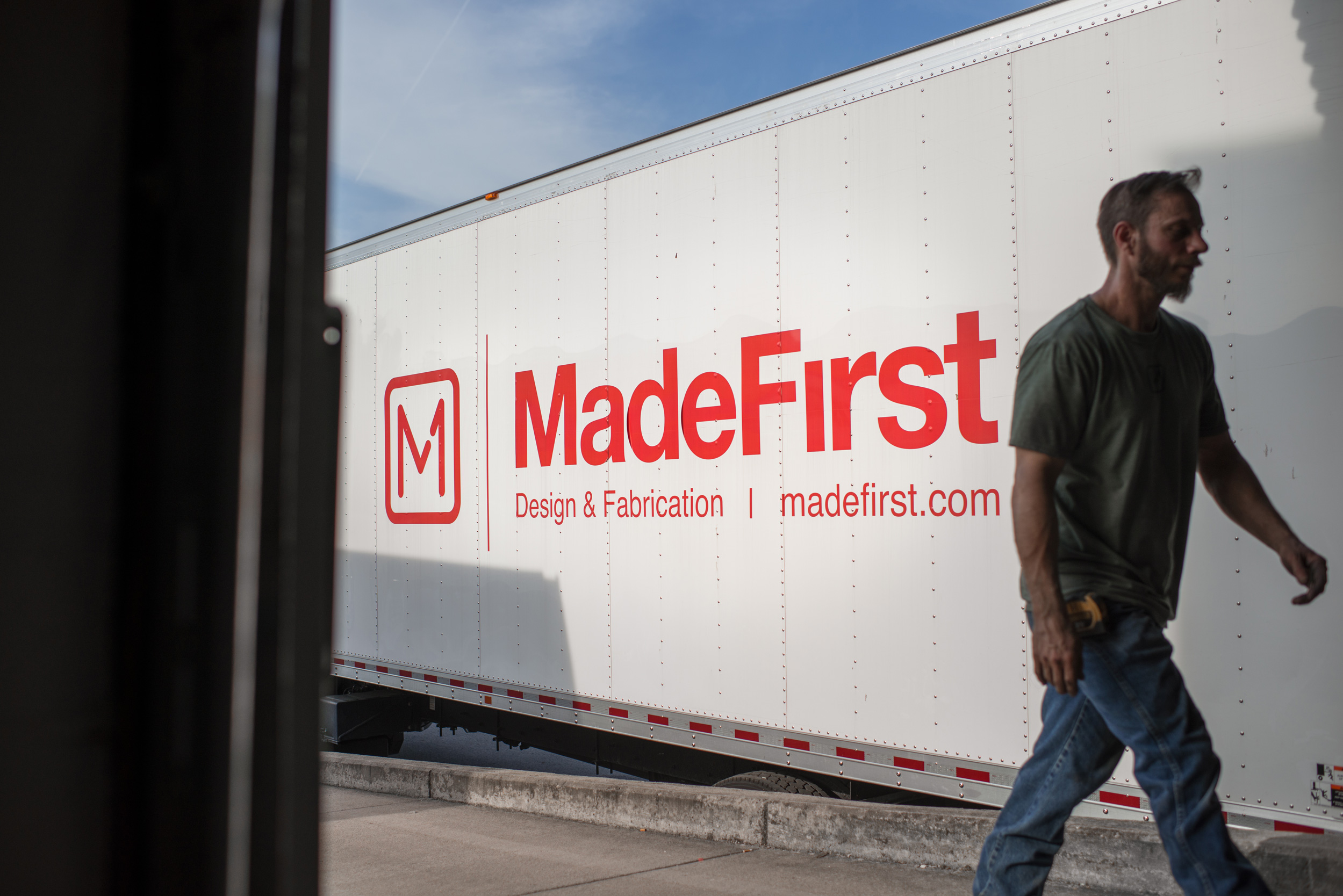 Man at a loading dock walking past a MadeFirst truck in Nashville, Tennessee
