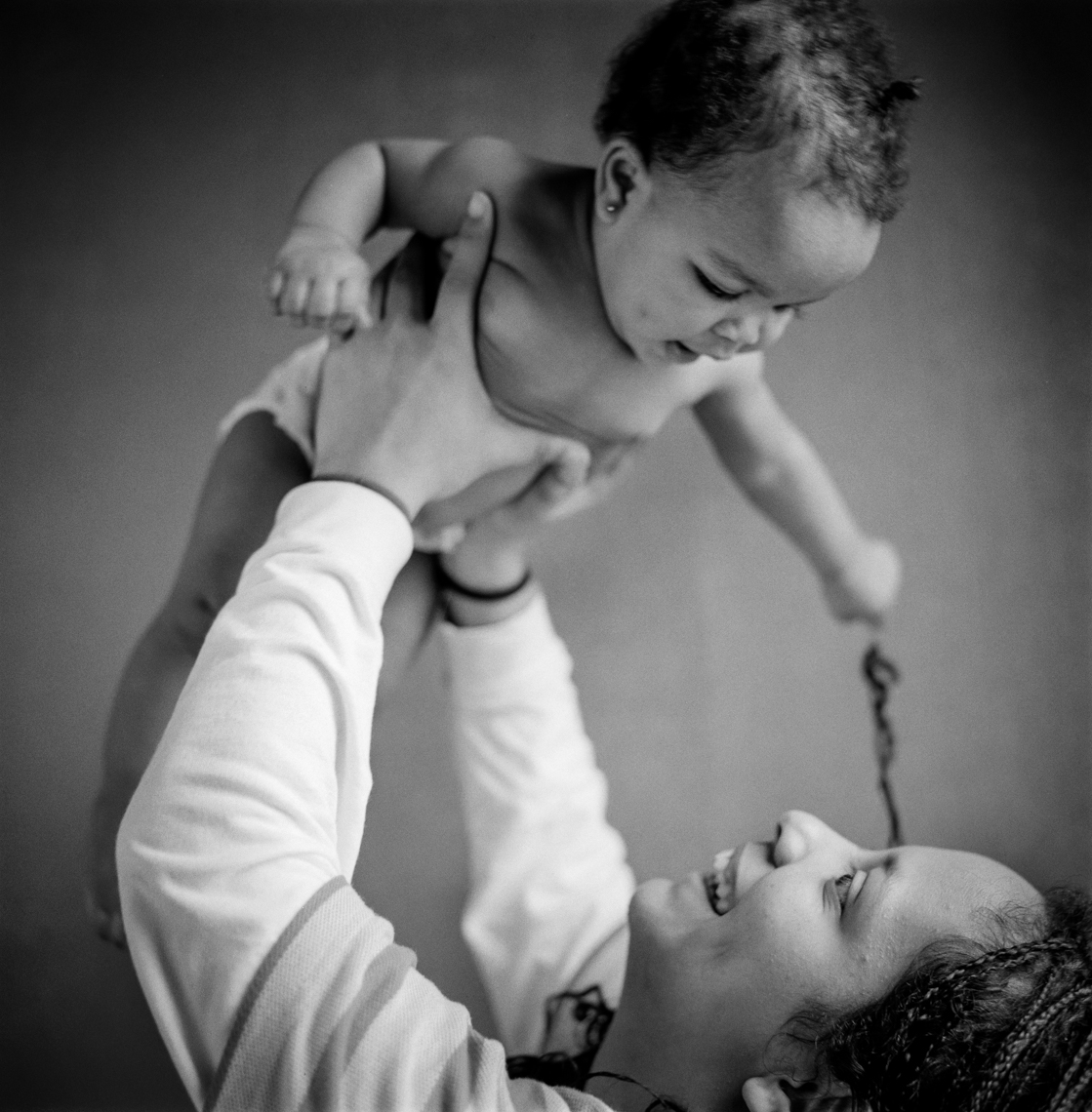 Young mother holding her daughter. Mother playing with her baby.  Nashville, Chicago, Washington, DC documentary and editorial portrait photographer photojournalist Kristina Krug
