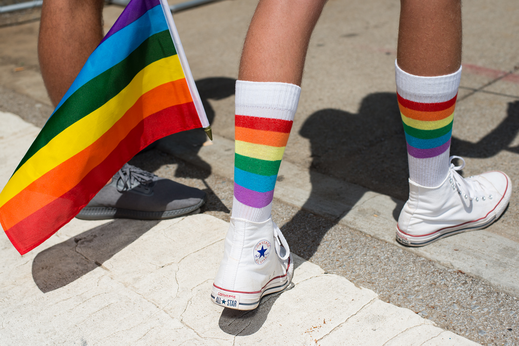 Pride socks and converse shoes on pavement during the Nashville Pride Festival in Nashville Tennessee. Photography by Kristina Krug. Tennessee has passed strict laws banning drag shows. Social issues, LGBTQ rights, advocacy, legal, Supreme Court.