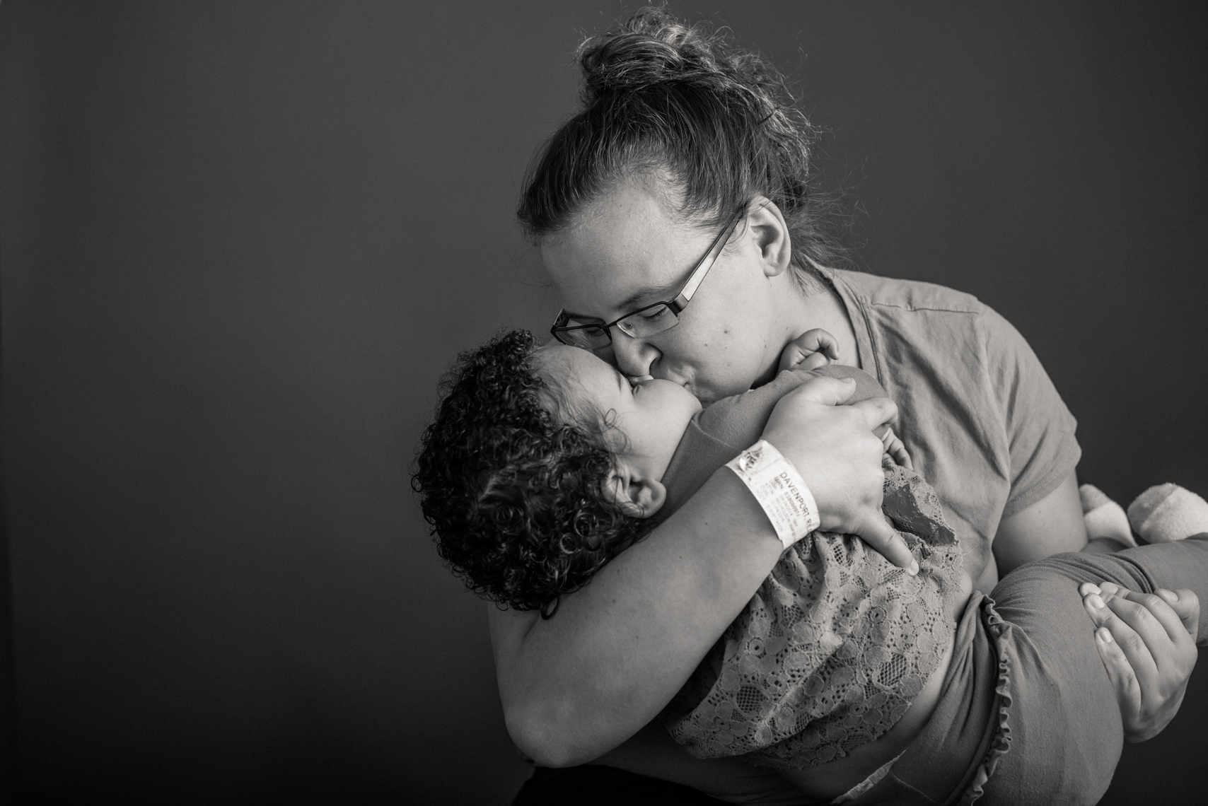 Flashes of Hope, portrait of a young mother kissing her daughter who is fighting cancer. Resilience, authentic, portrait, editorial, reportage, news, photographer, portraiture
