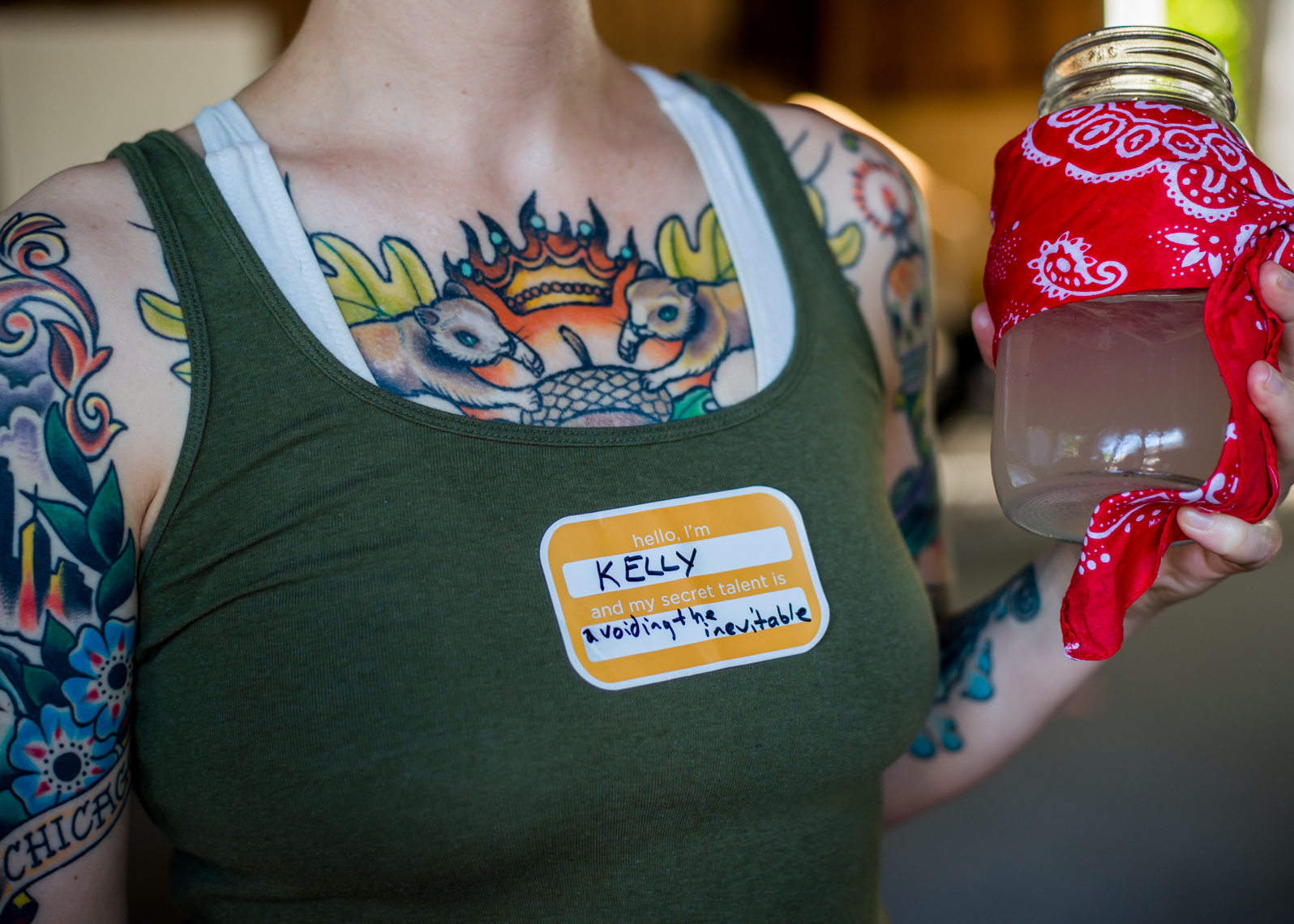 Kelly, woman with squirrel tattoos drinking from a ball jar in Little Rock, Arkansas