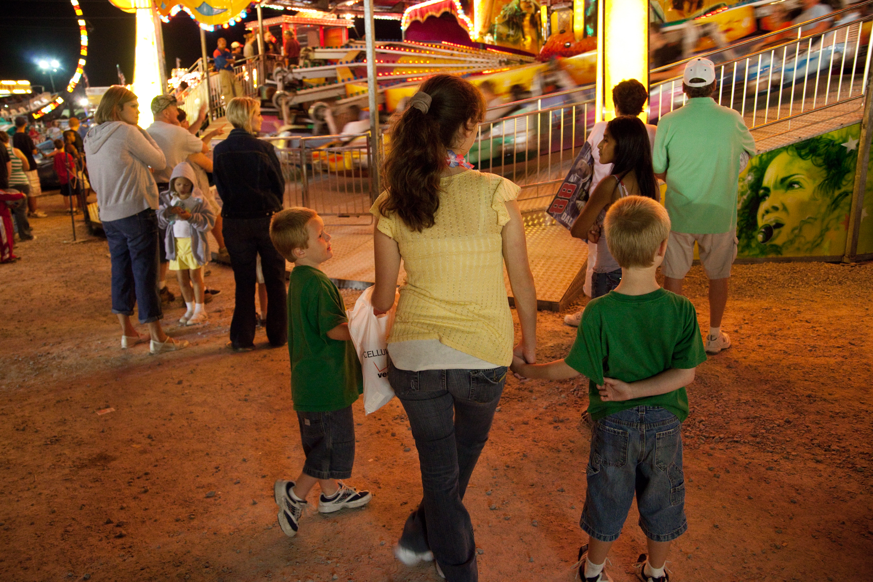 Young mother and her sons Wilson County Fair, Lebanon, Tennessee, carnival, amusement park ride