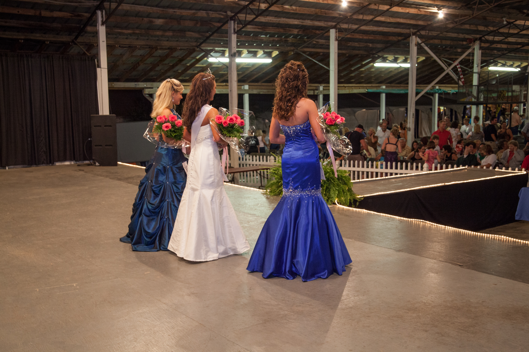 Teen beauty pageant contestants, winners, roses, flowers, barn, audience, stage, girls, Wilson County Fair, Lebanon, Tennessee, by Kristina Krug, editorial photographer documenting the rural south