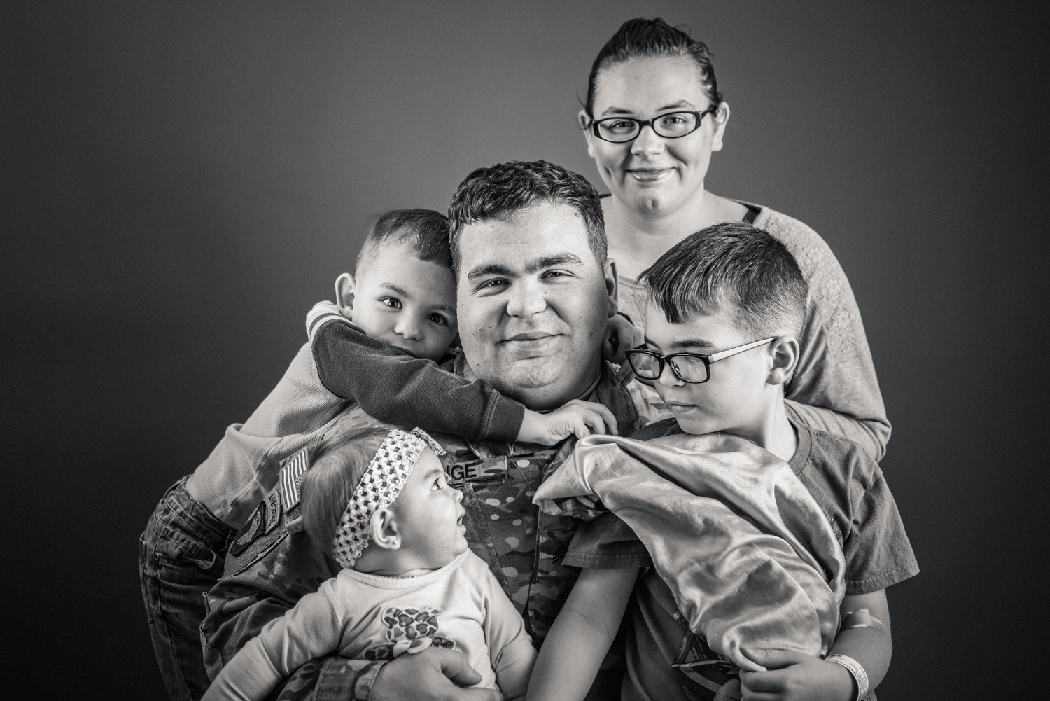 Hugs, military, father, mother, parent, couple with children, childhood, cancer, patient. Together, resilience, authentic, love, sports, fans, Nashville, editorial, documentary, photographer, real people, portrait, advertising, studio